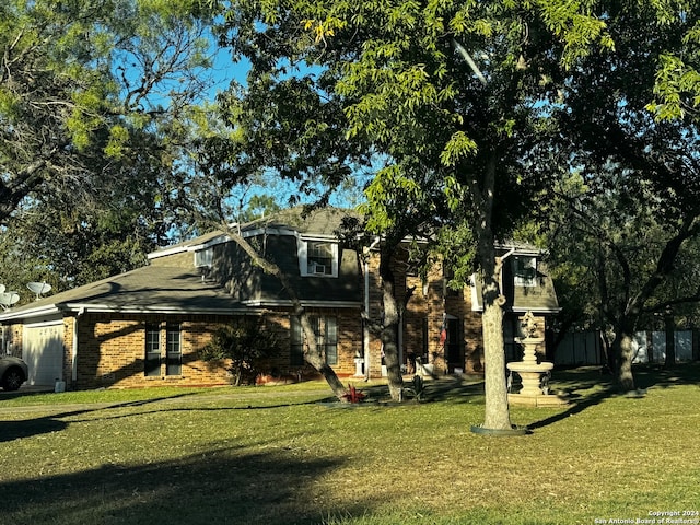 view of front facade with a front yard and a garage