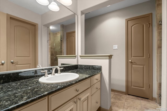 bathroom featuring tile patterned floors, vanity, and walk in shower