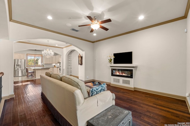 living room with dark hardwood / wood-style floors, sink, ornamental molding, and ceiling fan with notable chandelier