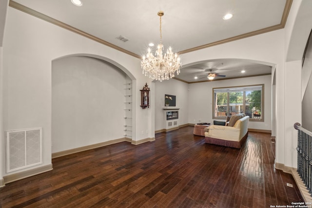 unfurnished living room featuring dark hardwood / wood-style floors, crown molding, and ceiling fan with notable chandelier