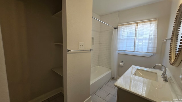 bathroom featuring vanity and tiled shower / bath