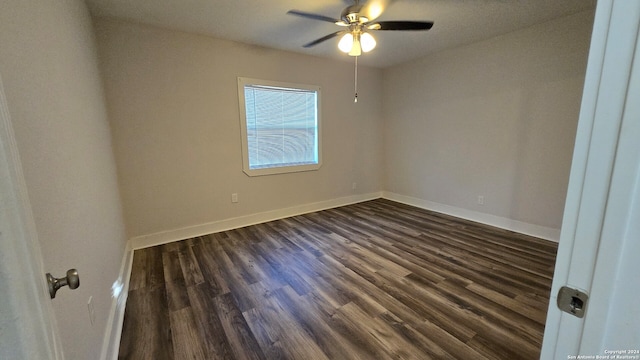 spare room with dark hardwood / wood-style floors and ceiling fan