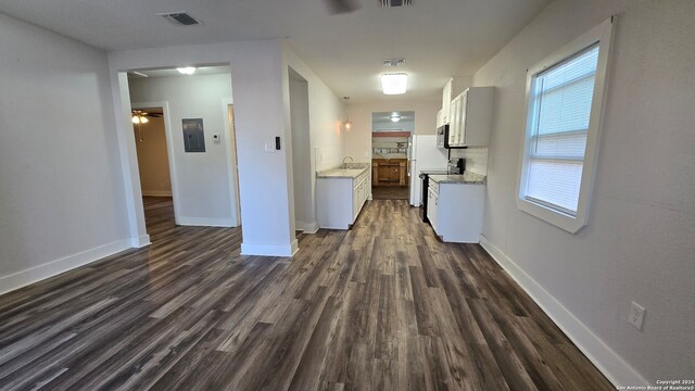 kitchen with ceiling fan, sink, electric range, white cabinets, and dark hardwood / wood-style floors