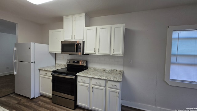 kitchen with stainless steel appliances, light stone counters, dark hardwood / wood-style flooring, backsplash, and white cabinets