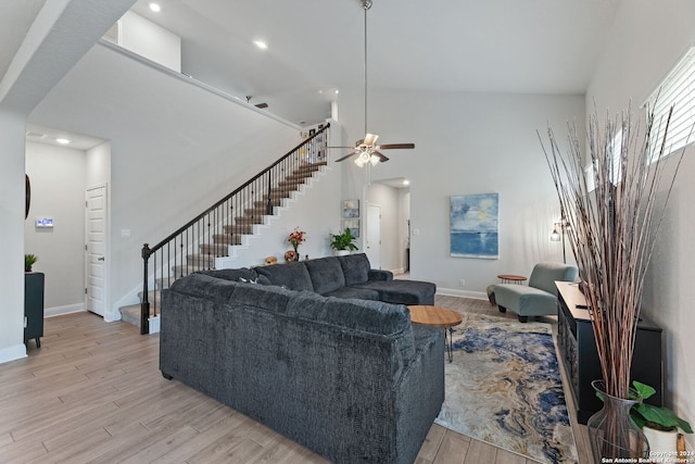 living room with high vaulted ceiling, light hardwood / wood-style flooring, and ceiling fan