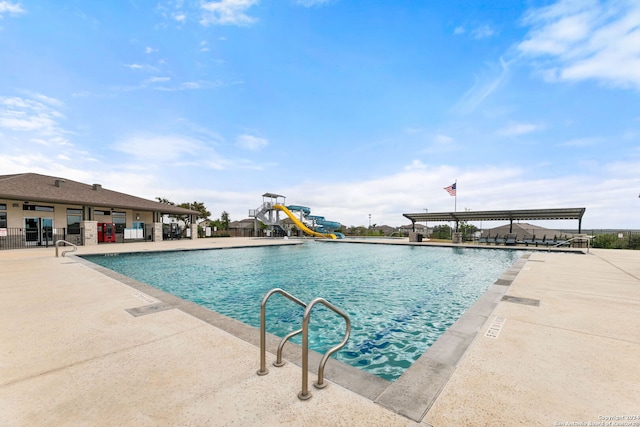 view of swimming pool featuring a patio area and a water slide