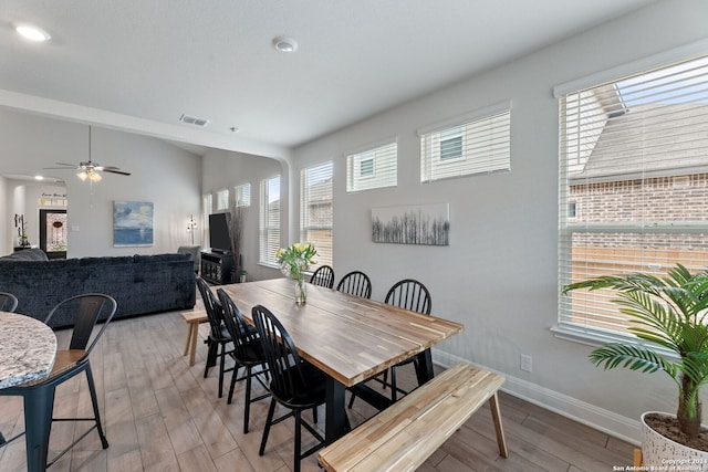 dining space featuring light wood-type flooring and ceiling fan