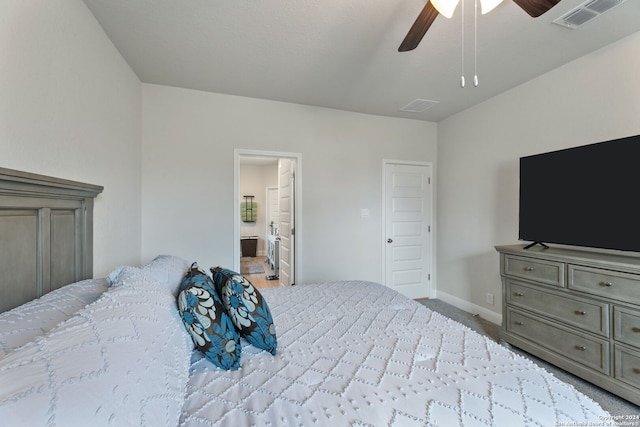 bedroom featuring carpet, ceiling fan, and ensuite bath