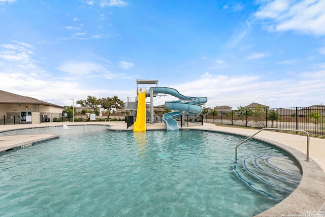 view of swimming pool with a patio area and a water slide