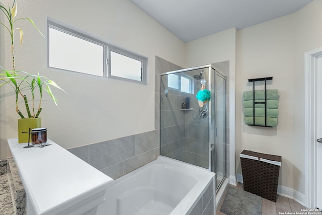 bathroom with shower with separate bathtub