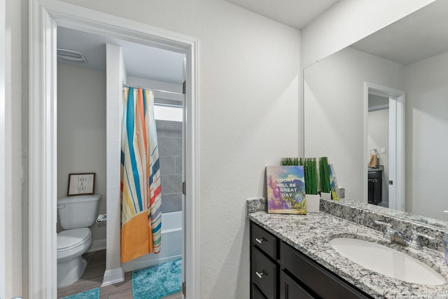 full bathroom with vanity, toilet, wood-type flooring, and shower / tub combo