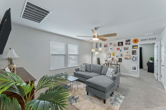 living room with ceiling fan and light colored carpet