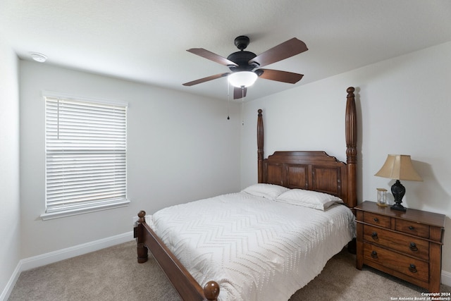 bedroom with light carpet and ceiling fan