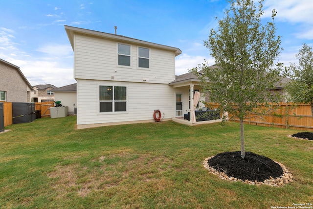 rear view of property with a yard