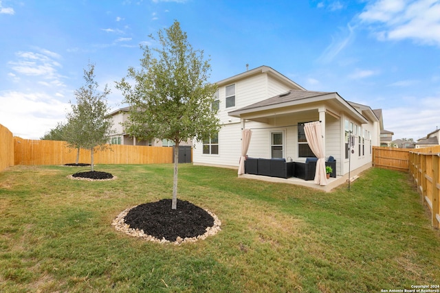 back of house featuring an outdoor hangout area and a yard