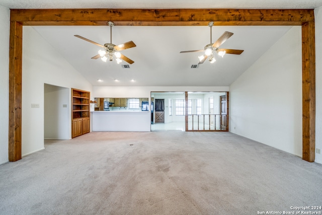 unfurnished living room with light carpet, high vaulted ceiling, ceiling fan, and beamed ceiling