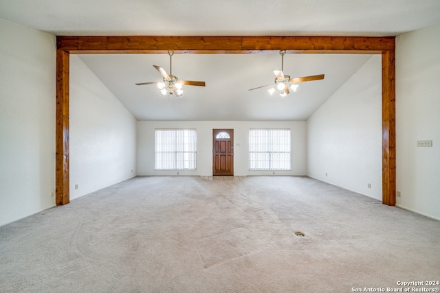 unfurnished living room featuring light carpet, high vaulted ceiling, and ceiling fan