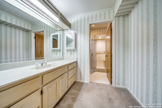 bathroom with vanity and a textured ceiling