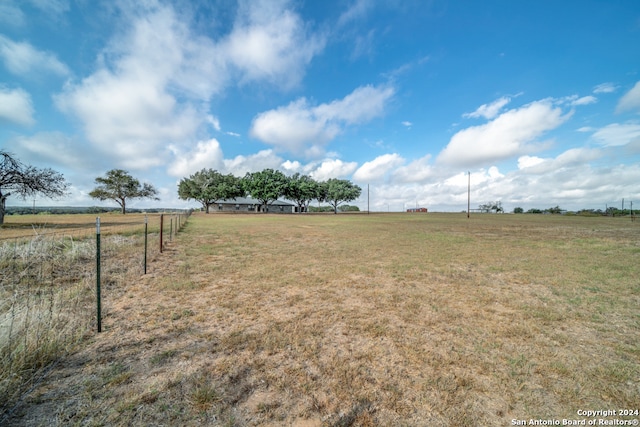 view of yard with a rural view