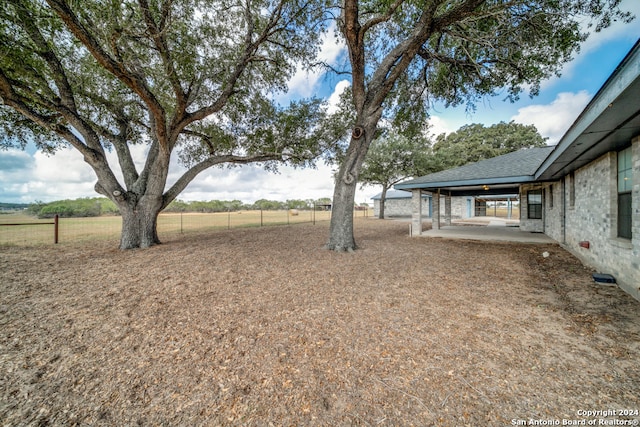 view of yard with a patio and a rural view