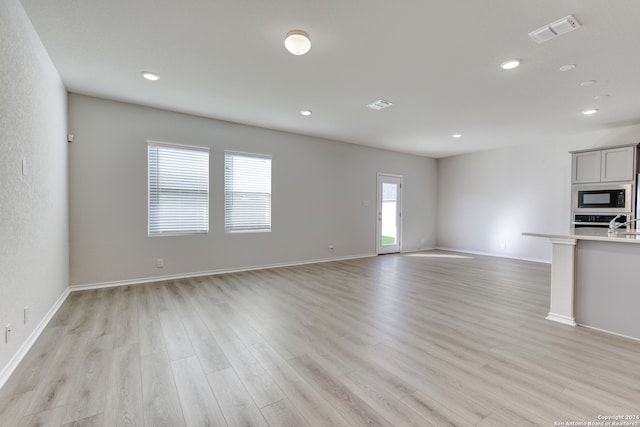 unfurnished living room with light hardwood / wood-style flooring