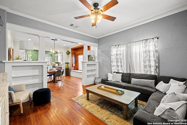 living room featuring light hardwood / wood-style floors, ornamental molding, and a wealth of natural light