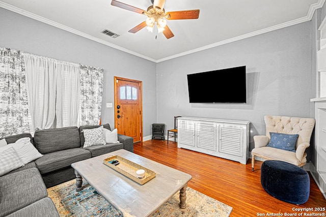 living room with hardwood / wood-style flooring, ceiling fan, and crown molding