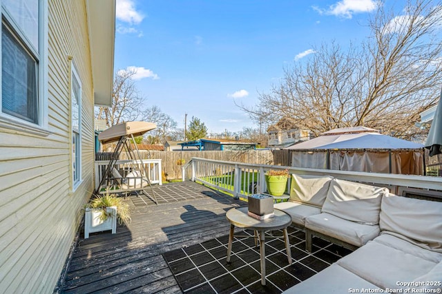 wooden deck featuring outdoor lounge area and a gazebo