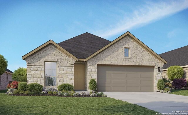 view of front of home featuring a garage and a front yard