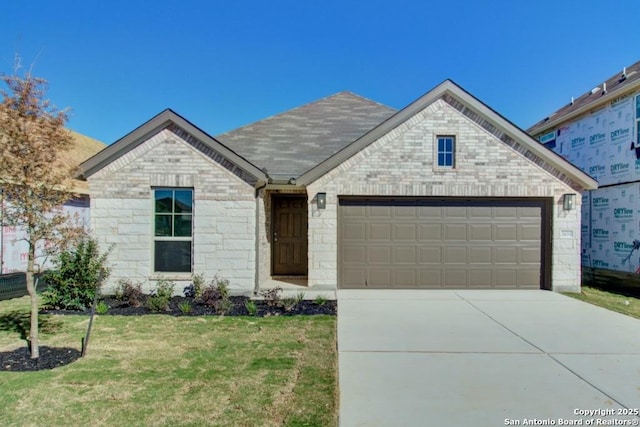 2631 Gideon Ln, New Braunfels, TX 78130 - view of front of property featuring a garage, driveway, a front yard, and stone siding