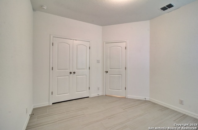 unfurnished bedroom featuring a closet and a textured ceiling