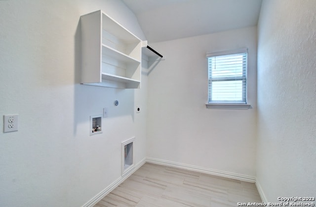 clothes washing area with hookup for an electric dryer, hookup for a gas dryer, and washer hookup