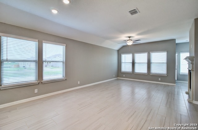 spare room with ceiling fan and lofted ceiling