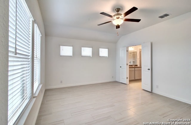 unfurnished room with ceiling fan and lofted ceiling