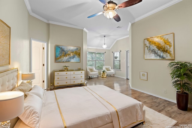 bedroom featuring ceiling fan, lofted ceiling, ornamental molding, and light hardwood / wood-style flooring