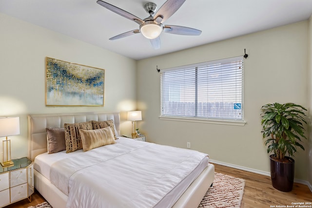 bedroom with hardwood / wood-style flooring and ceiling fan