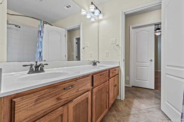 bathroom featuring tile patterned flooring, a shower with curtain, and vanity