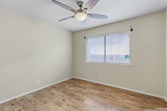 empty room with ceiling fan and light hardwood / wood-style floors