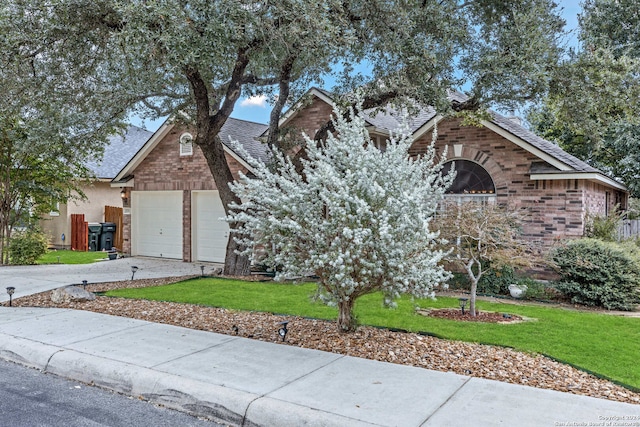 view of front of house with a front yard and a garage