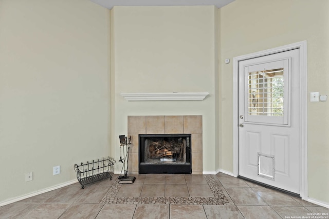 interior space featuring a tile fireplace and light tile patterned floors