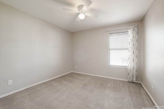 carpeted empty room with ceiling fan