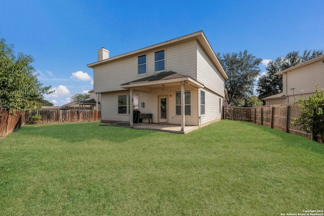 back of property featuring a yard and a patio area