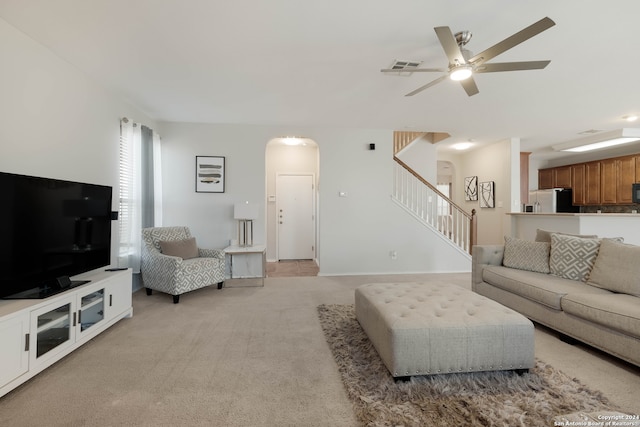 carpeted living room featuring ceiling fan