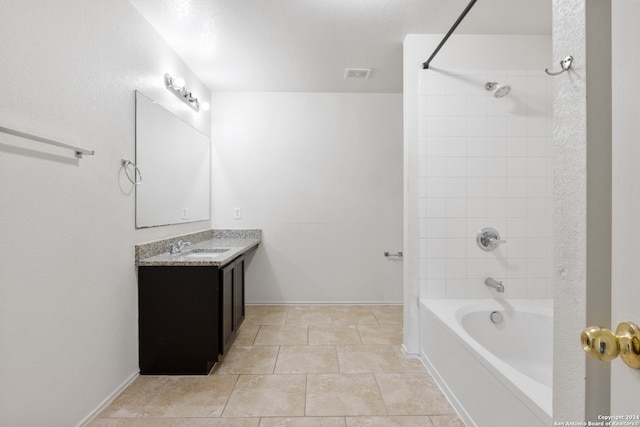 full bathroom featuring baseboards, washtub / shower combination, visible vents, and vanity