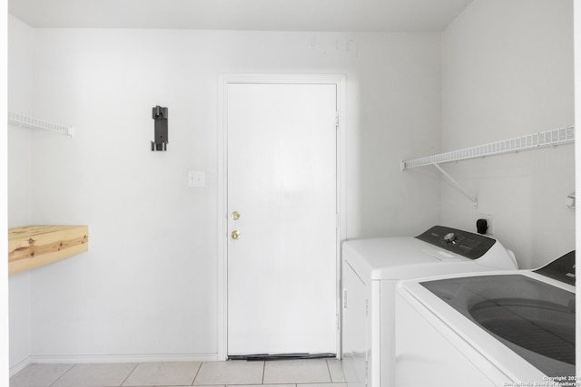 laundry area featuring independent washer and dryer and light tile patterned floors