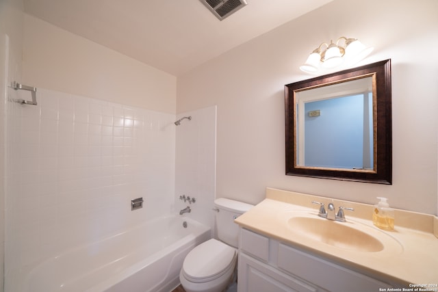 full bathroom featuring vanity, tiled shower / bath combo, and toilet