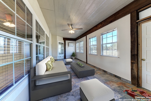 sunroom featuring ceiling fan