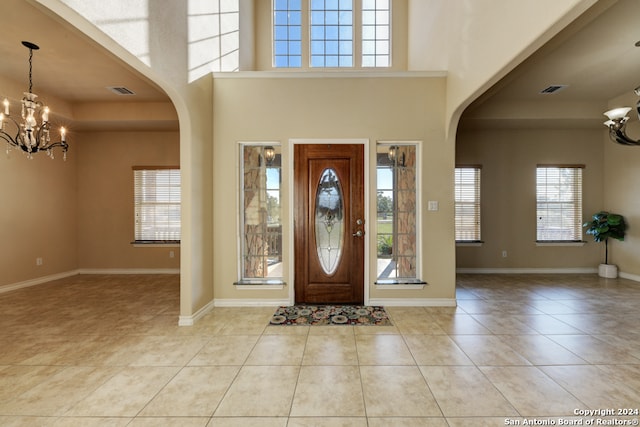 entrance foyer featuring light tile patterned floors and a chandelier