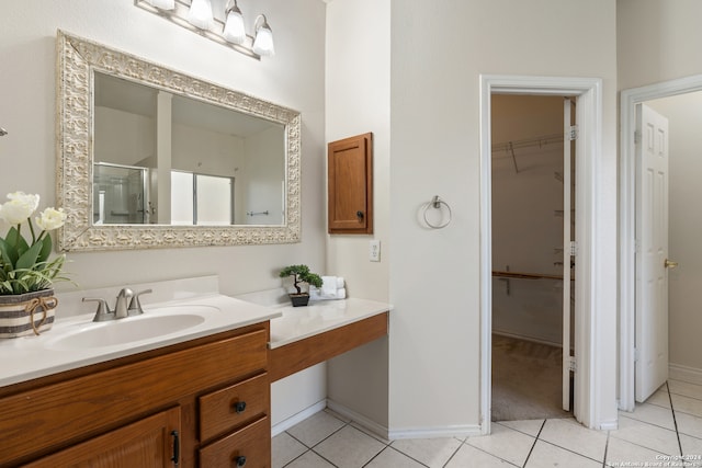 bathroom featuring tile patterned floors, vanity, and walk in shower