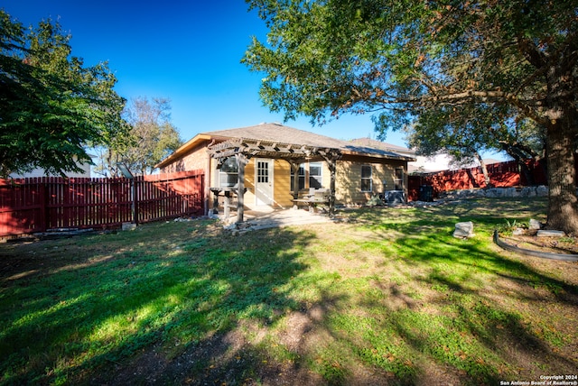 rear view of house featuring a patio area and a yard